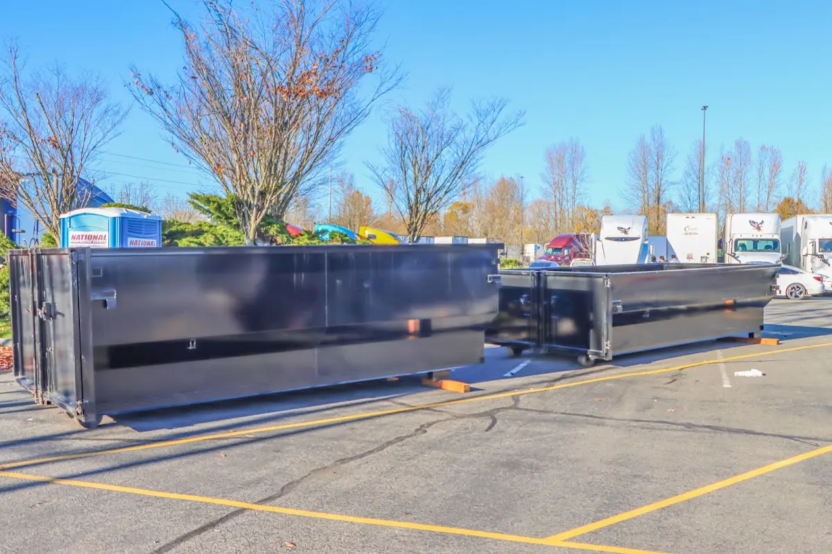 Professional dumpster rental service with roll-off container on residential driveway in Brownsburg